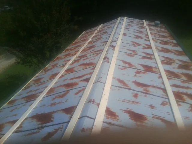 Rusted metal roof panels with new wood purlins before replacement — Storm Damage Roof Repair in Angleton by Roofing Brothers